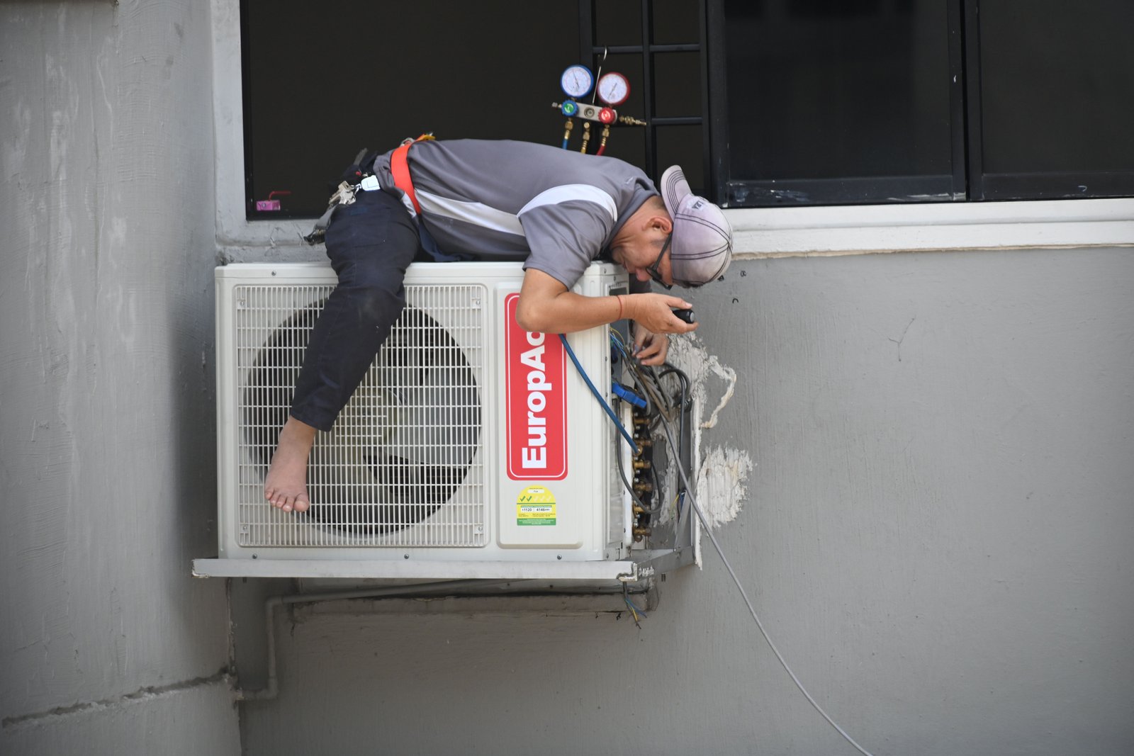 HVAC technician diagnosing emergency  furnace problem with diagnostic tools in Spokane
